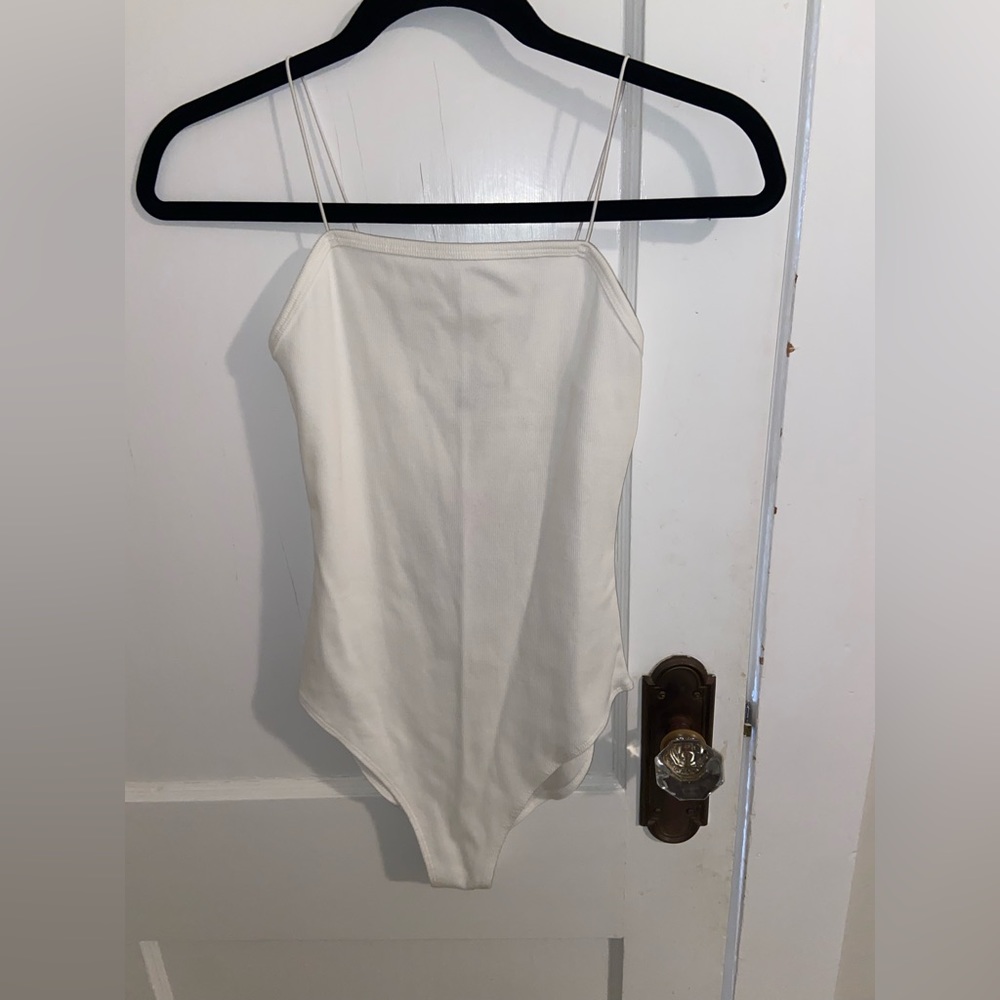 New with tags. Never worn. White spaghetti strap bodysuit